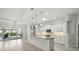 Bright kitchen with a large island, pendant lighting, stainless appliances, and access to the backyard at 3048 Borassus Dr, New Smyrna Beach, FL 32168