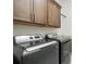 Laundry room featuring modern washer and dryer units and storage cabinets at 3048 Borassus Dr, New Smyrna Beach, FL 32168