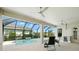 A covered patio with ceiling fans overlooks a private screened pool at 3048 Borassus Dr, New Smyrna Beach, FL 32168