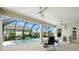 A covered patio with ceiling fans overlooks a private screened pool at 3048 Borassus Dr, New Smyrna Beach, FL 32168