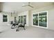 Screened-in patio with ceiling fans offers views of a private pool at 3048 Borassus Dr, New Smyrna Beach, FL 32168