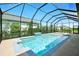 A screened in pool with a built in spa offers privacy and relaxation at 3048 Borassus Dr, New Smyrna Beach, FL 32168