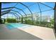 A private screened pool and spa are surrounded by lush landscaping at 3048 Borassus Dr, New Smyrna Beach, FL 32168