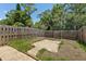 Fenced backyard with a small patio area surrounded by lush greenery at 3522 Forest Branch Dr # D, Port Orange, FL 32129