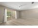 Bright bedroom with neutral walls and a sliding glass door leading to a private outdoor space at 3522 Forest Branch Dr # D, Port Orange, FL 32129
