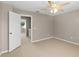 Empty bedroom with neutral walls, carpet, and a door, perfect for creating a cozy and personalized living space at 3522 Forest Branch Dr # D, Port Orange, FL 32129