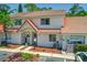 Charming two-story townhome with well-maintained landscaping and a classic red tile roof at 3522 Forest Branch Dr # D, Port Orange, FL 32129