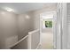 Hallway with neutral walls, a large closet, and an open door with a bedroom view; carpeted and with a ceiling light at 3522 Forest Branch Dr # D, Port Orange, FL 32129