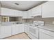 Efficient kitchen featuring white appliances, cabinets, and ample counter space for meal prep at 3522 Forest Branch Dr # D, Port Orange, FL 32129
