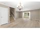 Bright living room with new floors, stairs and glass doors providing access to the outside at 3522 Forest Branch Dr # D, Port Orange, FL 32129