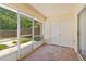 Screened-in patio with tiled floor and view of the backyard at 3522 Forest Branch Dr # D, Port Orange, FL 32129