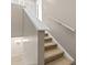 Carpeted staircase with white railing in a neutrally decorated home provides safe and comfortable access to other floors at 3522 Forest Branch Dr # D, Port Orange, FL 32129