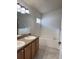 Bathroom features dual sinks, vanity with granite counters, tile floors, and soaking tub at 465 Dahoon Holly Dr, Daytona Beach, FL 32117