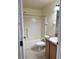 Bathroom featuring a tub and shower combo, toilet, and vanity with sink and wood cabinets at 465 Dahoon Holly Dr, Daytona Beach, FL 32117
