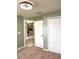Cozy bedroom with neutral carpet, two closets, and a view to a kitchen space at 465 Dahoon Holly Dr, Daytona Beach, FL 32117