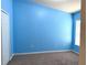 Bright bedroom with blue walls, neutral carpet, and a window for natural light at 465 Dahoon Holly Dr, Daytona Beach, FL 32117