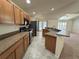 Modern kitchen featuring wood cabinets, stainless steel appliances, and a breakfast bar at 465 Dahoon Holly Dr, Daytona Beach, FL 32117