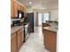 Functional kitchen with wood cabinets, granite countertops, and stainless steel appliances at 465 Dahoon Holly Dr, Daytona Beach, FL 32117