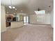 Spacious living area with carpet, high ceilings, skylight, and open kitchen view at 465 Dahoon Holly Dr, Daytona Beach, FL 32117