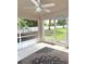 Screened lanai with outdoor ceiling fan, concrete floor with rug, and view of the backyard at 465 Dahoon Holly Dr, Daytona Beach, FL 32117