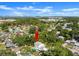 Aerial view of a home with a pool surrounded by lush trees, indicating a private and serene setting at 506 Dorset Cir, South Daytona, FL 32119