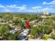 Stunning aerial view of a property nestled among lush greenery, with city skyline in the distance at 506 Dorset Cir, South Daytona, FL 32119
