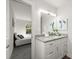 Bathroom featuring a granite countertop, white cabinets, and a view into the bedroom at 506 Dorset Cir, South Daytona, FL 32119