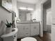 Bright bathroom features granite counters, white cabinets, and decorative accents at 506 Dorset Cir, South Daytona, FL 32119