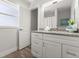 Bathroom featuring a granite countertop, white cabinets, and wood-style flooring at 506 Dorset Cir, South Daytona, FL 32119