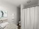 Bathroom featuring a granite countertop, white cabinets, and a shower with a white curtain at 506 Dorset Cir, South Daytona, FL 32119