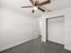 Neutral bedroom with a ceiling fan and walk-in closet at 506 Dorset Cir, South Daytona, FL 32119