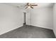 Neutral bedroom with a ceiling fan and wall-to-wall gray carpeting at 506 Dorset Cir, South Daytona, FL 32119