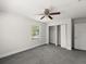 Carpeted bedroom features natural light and closet space at 506 Dorset Cir, South Daytona, FL 32119