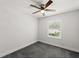 Bright bedroom with ceiling fan and large window at 506 Dorset Cir, South Daytona, FL 32119