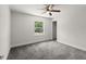 Carpeted bedroom features window with view to the outdoors at 506 Dorset Cir, South Daytona, FL 32119