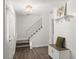 Bright foyer featuring a staircase, stylish light fixture, and a decorative bench with coat hooks at 506 Dorset Cir, South Daytona, FL 32119