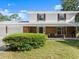 Charming two-story home featuring a welcoming front porch with brick accents and a well-maintained lawn at 506 Dorset Cir, South Daytona, FL 32119