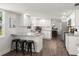 Bright, spacious kitchen with white cabinetry, granite countertops, and a convenient breakfast bar at 506 Dorset Cir, South Daytona, FL 32119