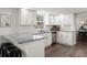 Bright kitchen features white cabinets, granite countertops and stainless steel appliances at 506 Dorset Cir, South Daytona, FL 32119