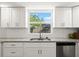 Bright kitchen featuring stainless steel appliances, granite counters, and a view of the backyard at 506 Dorset Cir, South Daytona, FL 32119