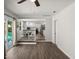 Bright open living room with view to backyard pool and adjacent kitchen at 506 Dorset Cir, South Daytona, FL 32119