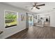 Open living room with sliding door to pool and view to the kitchen at 506 Dorset Cir, South Daytona, FL 32119