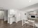 Open living area with adjacent kitchen, featuring white brick fireplace and modern finishes at 506 Dorset Cir, South Daytona, FL 32119
