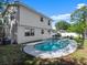Backyard with a kidney-shaped pool and a view of the white two-story house at 506 Dorset Cir, South Daytona, FL 32119