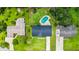An aerial view of a lovely home with well-manicured lawn, pool and privacy fence at 950 Pineapple Rd, South Daytona, FL 32119