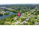 Waterfront home with large lawn, bordered by mature trees, and situated on a cul-de-sac at 950 Pineapple Rd, South Daytona, FL 32119