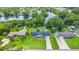 Aerial view of a home with a pool and lush surroundings, near a beautiful lake at 950 Pineapple Rd, South Daytona, FL 32119