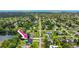 Lakeside home featuring a pool and lush landscaping, offering serene waterfront living at 950 Pineapple Rd, South Daytona, FL 32119