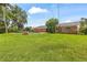Expansive backyard featuring a pool, brick accents, and verdant lawn perfect for relaxation at 950 Pineapple Rd, South Daytona, FL 32119