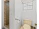 Bathroom with a toilet, towel bar, and a shower with tile walls at 950 Pineapple Rd, South Daytona, FL 32119